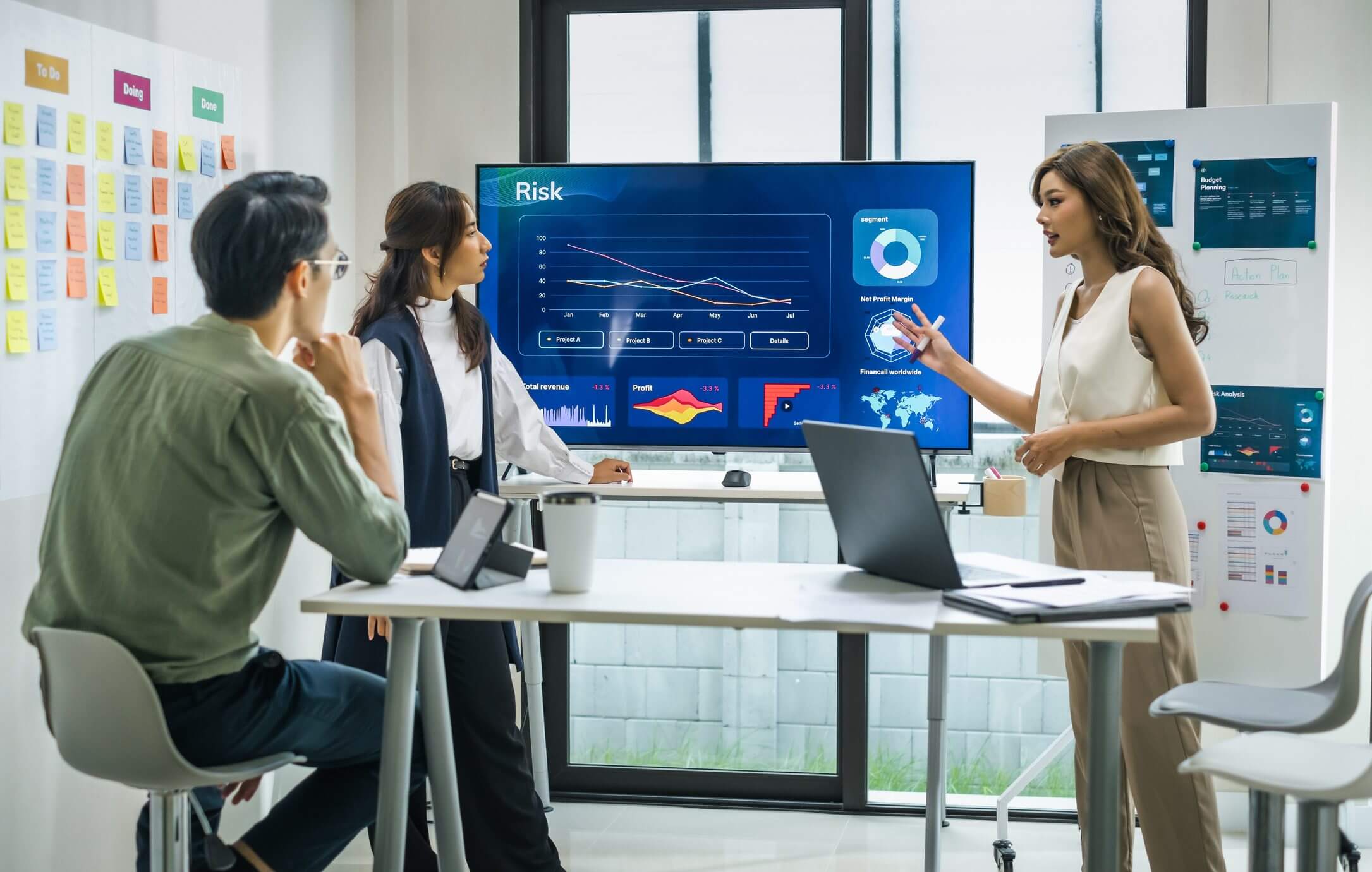 Business team analyzing data charts in a modern office meeting.