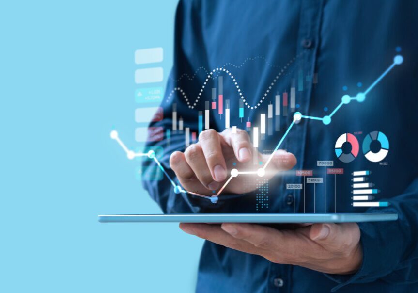 Person interacting with digital financial graphs.